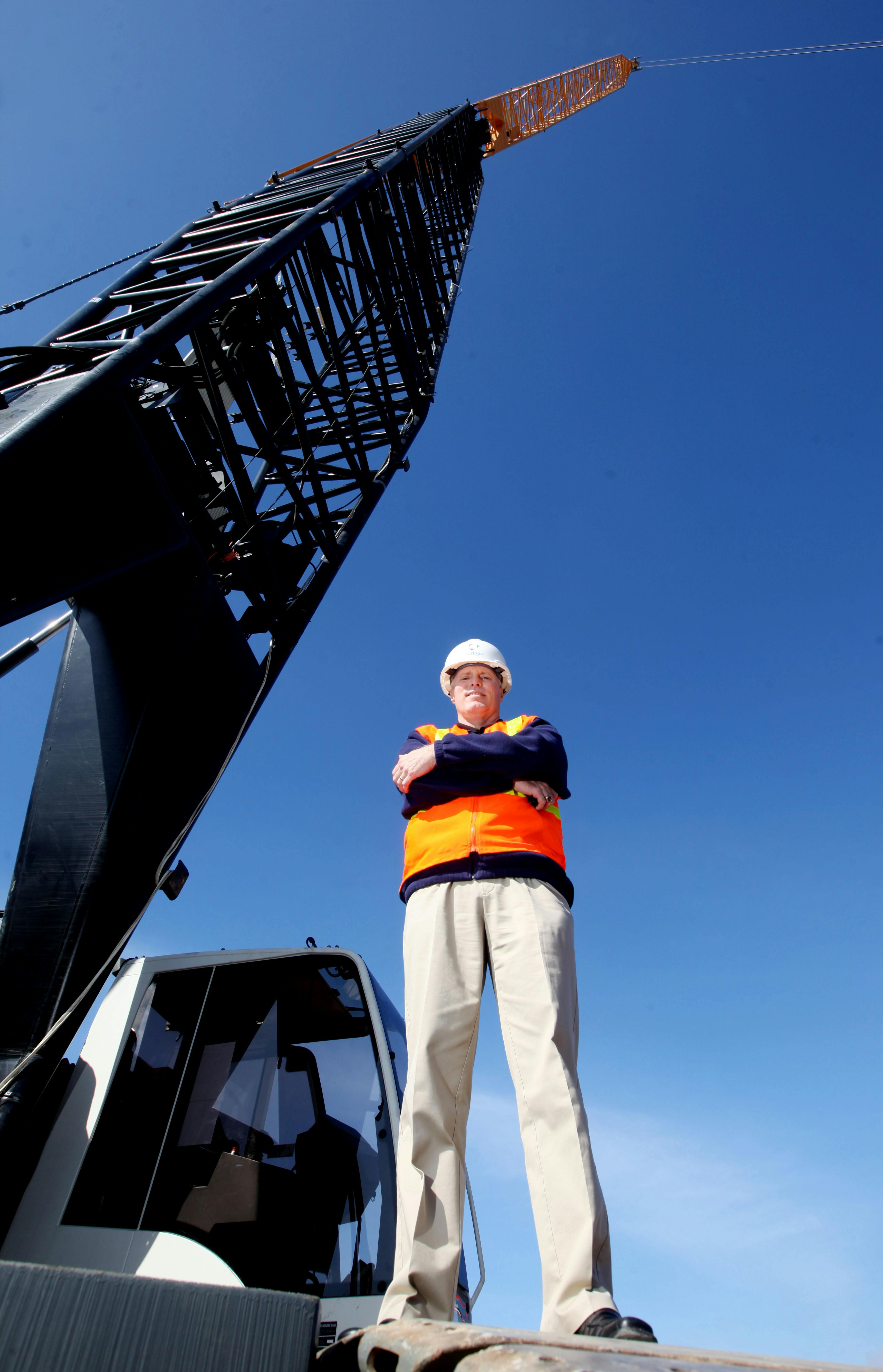 Chris Van Gorder, president and CEO, Scripps Health, stands before the crane that will be used to erect seven stories of structu
