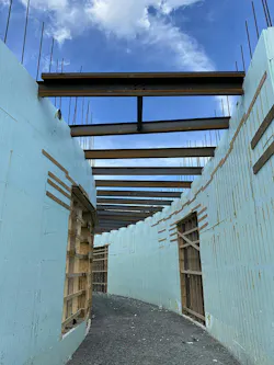 A photo of light blue curved ICF walls during building construction A photo of light blue curved ICF walls during building construction