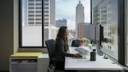 Office worker at desk by window Office worker at desk by window