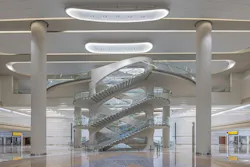View of the Arrivals Hall Feature Staircase at Zayed International Airport, Terminal A. Photo: Victor Romero, courtesy Kohn Pedersen Fox (KPF) View of the Arrivals Hall Feature Staircase at Zayed International Airport, Terminal A. Photo: Victor Romero, courtesy Kohn Pedersen Fox (KPF)