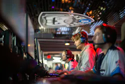 Gamers playing games in esports arena Gamers playing games in esports arena