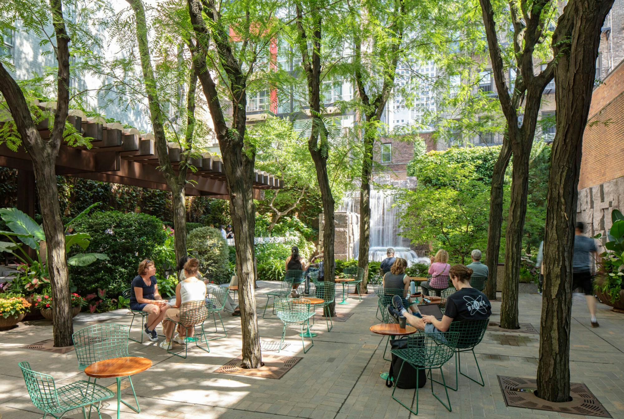 Greenacre Park in midtown Manhattan creates a cool and shady microclimate with a pergola, honey locusts, and a misty water feature