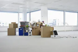 Empty Office With Boxes. Cartons and equipment on floor of empty office space Empty Office With Boxes. Cartons and equipment on floor of empty office space