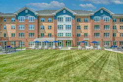 Outdoor grass area in modern senior living facility Outdoor grass area in modern senior living facility
