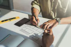 Architects or engineer construction discussing about interior design project with blueprints in architects office workplace Architects or engineer construction discussing about interior design project with blueprints in architects office workplace