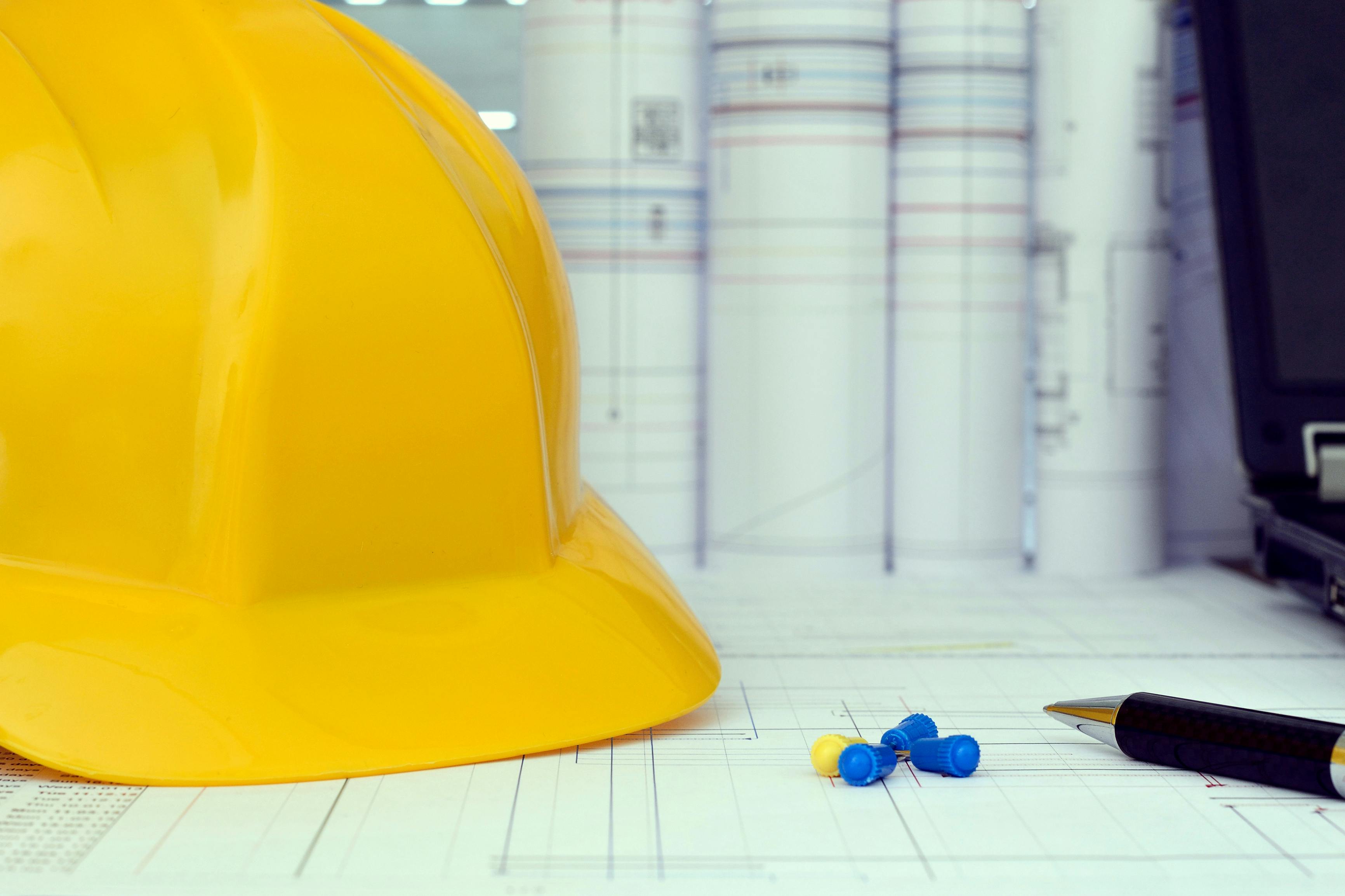 Construction project management tools - helmet, drawings and planning