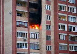Fire in the multifamily house. Fire in one of the apartments of a large tenement-house Fire in the multifamily house. Fire in one of the apartments of a large tenement-house
