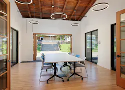 Flex room at north wing. Bifold doors create reinforce indoor/outdoor relationships. Floor is salvaged maple gymnasium floor (refinished). Flex room at north wing. Bifold doors create reinforce indoor/outdoor relationships. Floor is salvaged maple gymnasium floor (refinished).