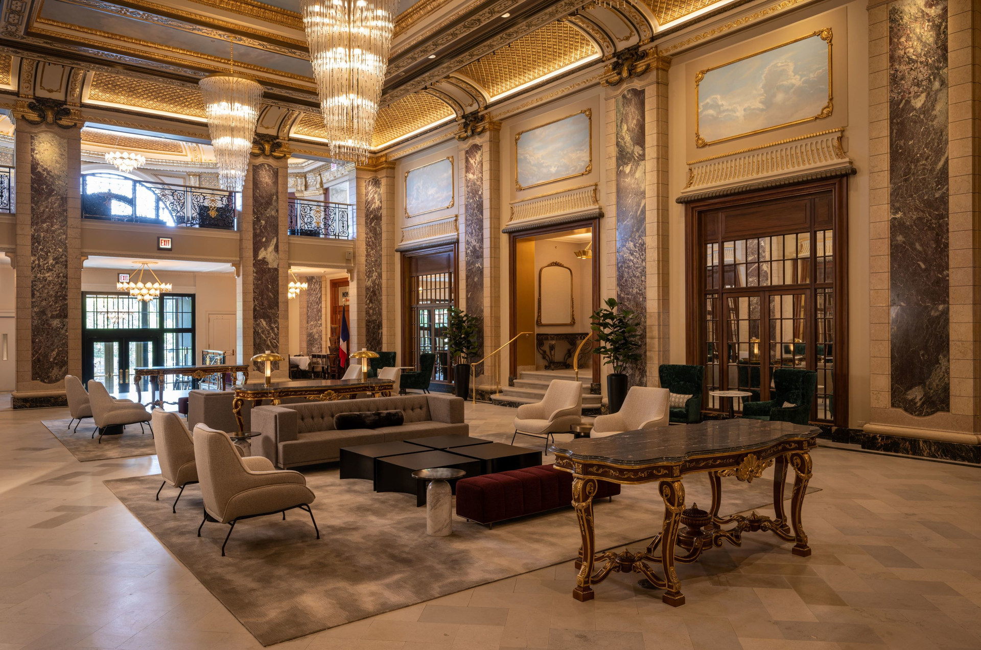 The Belden-Stratford&rsquo;s ornate double-height lobby features restored original elements such as gilded plaster molding and gold-leaf detailing.