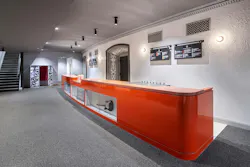 Long, orange bar area with historic architectural details around door framing. Long, orange bar area with historic architectural details around door framing.