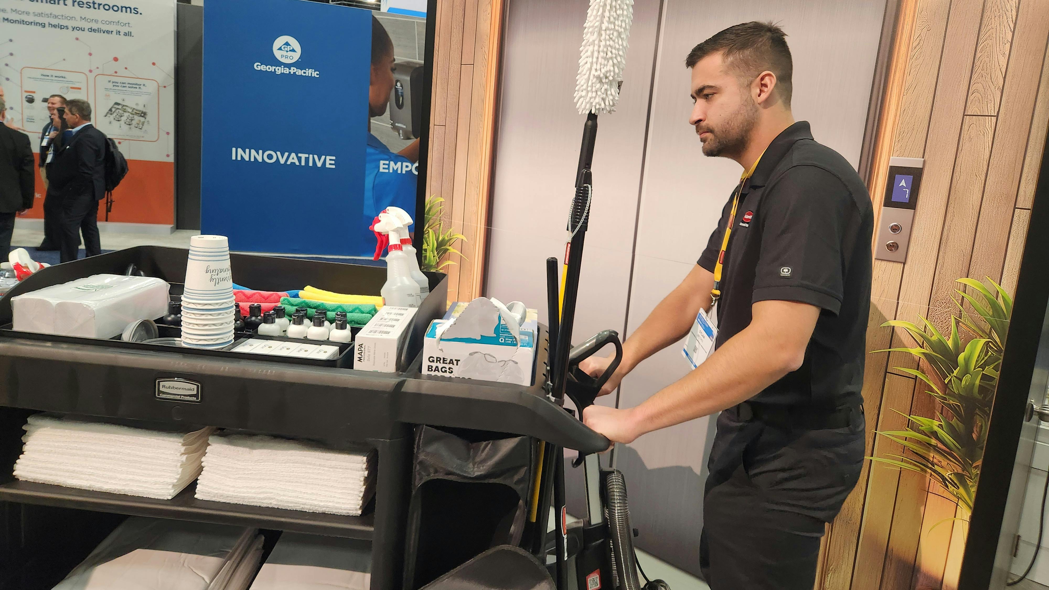 Dylan Brooks, key account manager with Rubbermaid Commercial Products, demonstrates the company&rsquo;s updated housekeeping cart.