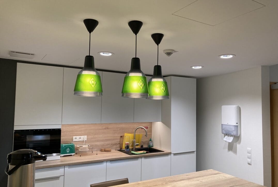 Signify continues to advance its sustainability initiatives, including 3D printing of products such as the pendants pictured above, made from recycled material for fans of Germany&rsquo;s Werder Bremen soccer team.