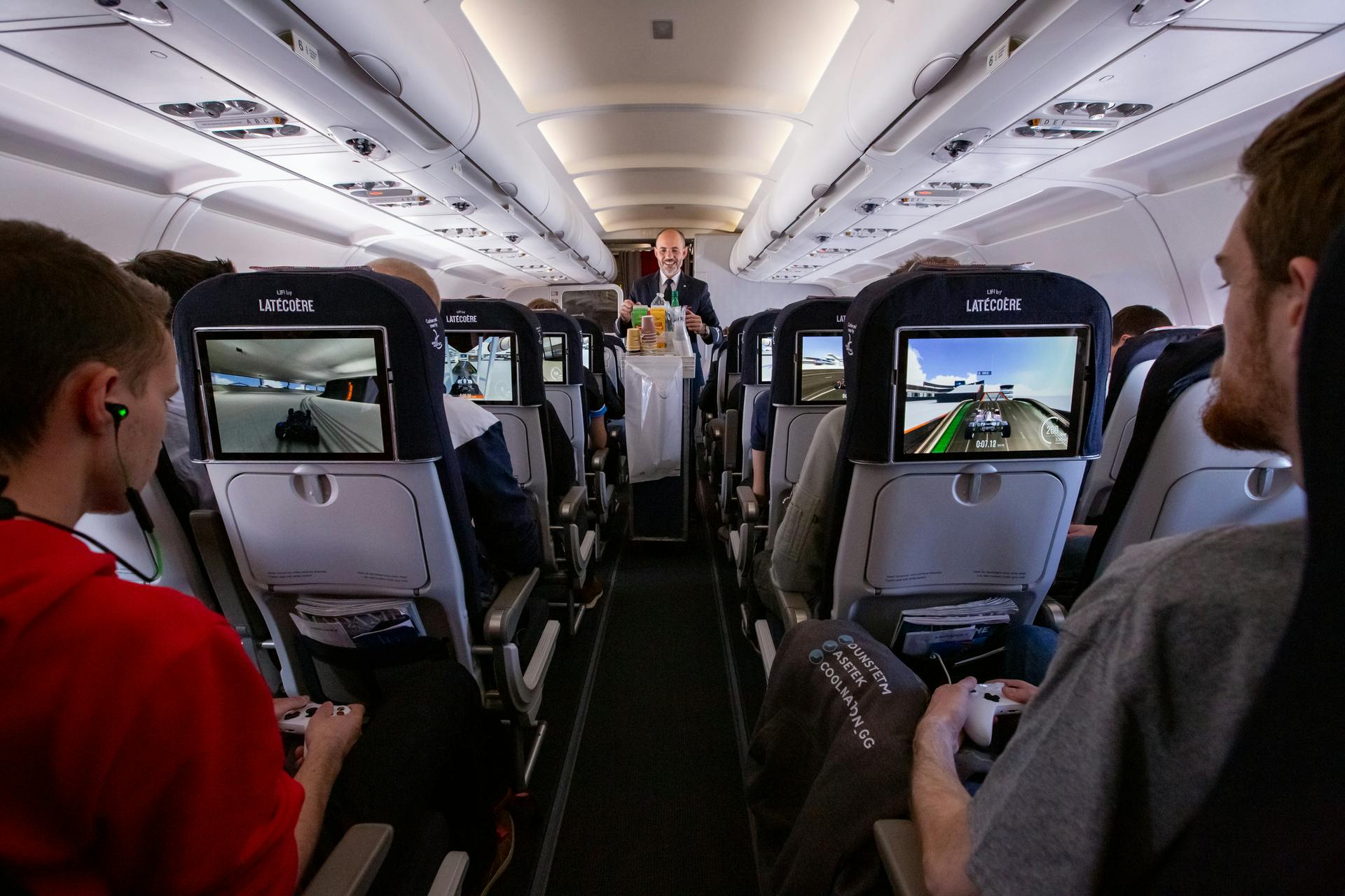 The tray tables are up, but the Li-Fi wasn&rsquo;t always in the right position as finalists competed in a gaming competition aboard an Air France Paris-to-Toulouse flight. (Photo credit: Image courtesy of Air France.)