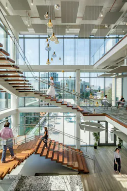 A monumental staircase, meant to encourage movement and conversation, was designed and created by Heirloom Companies, a South Carolina wood and iron artisan. It was designed in a way that minimizes obstruction of the outdoors via floor-to-ceiling windows. A monumental staircase, meant to encourage movement and conversation, was designed and created by Heirloom Companies, a South Carolina wood and iron artisan. It was designed in a way that minimizes obstruction of the outdoors via floor-to-ceiling windows.