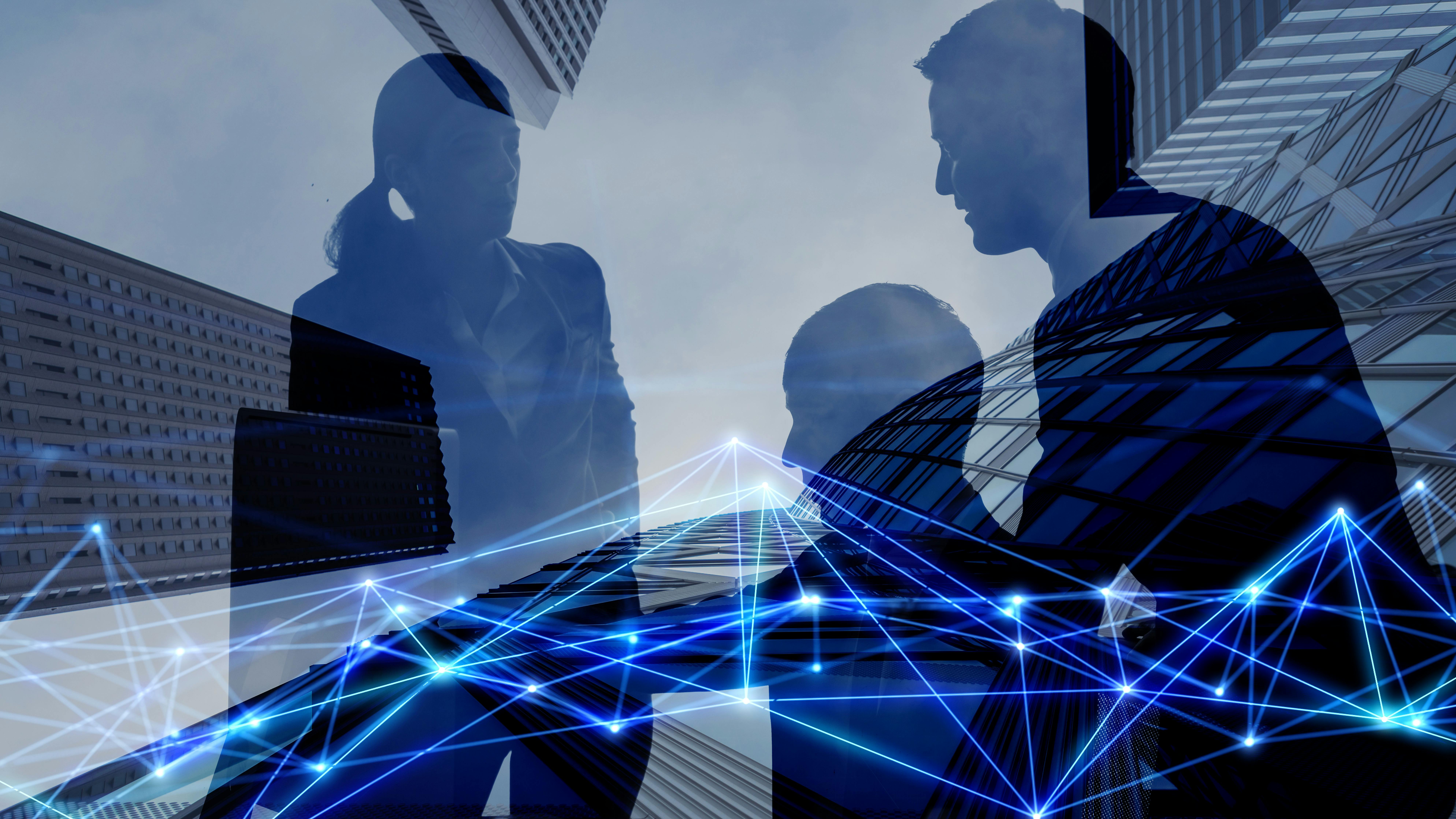 Computer-generated image of three silhouetted people and buildings overlayed with connected lines signaling technology.