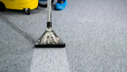 A janitor cleans a carpet. A janitor cleans a carpet.