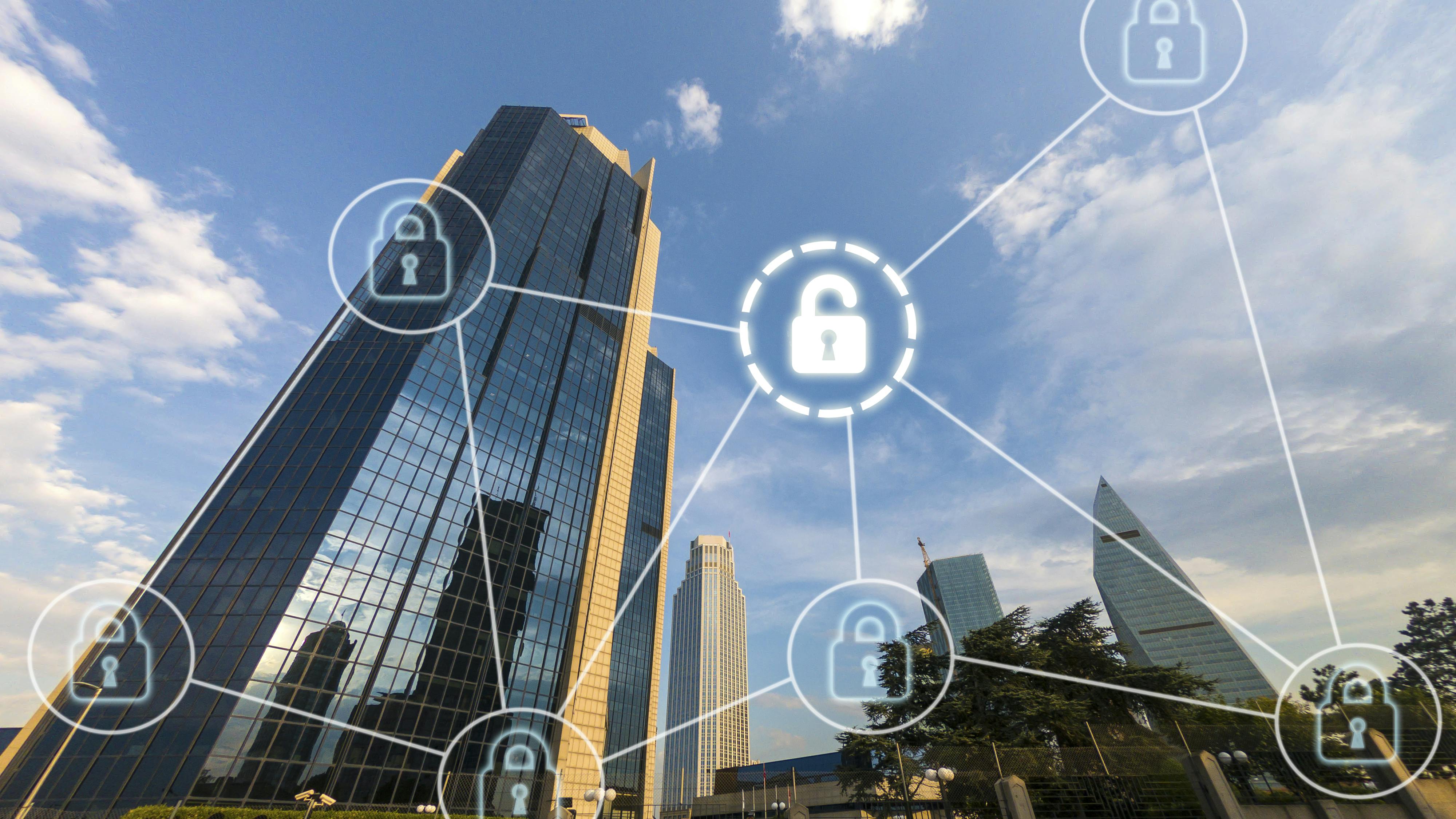 Tall commercial buildings skyline with digital overlay of interconnected pad locks as cybersecurity concept.