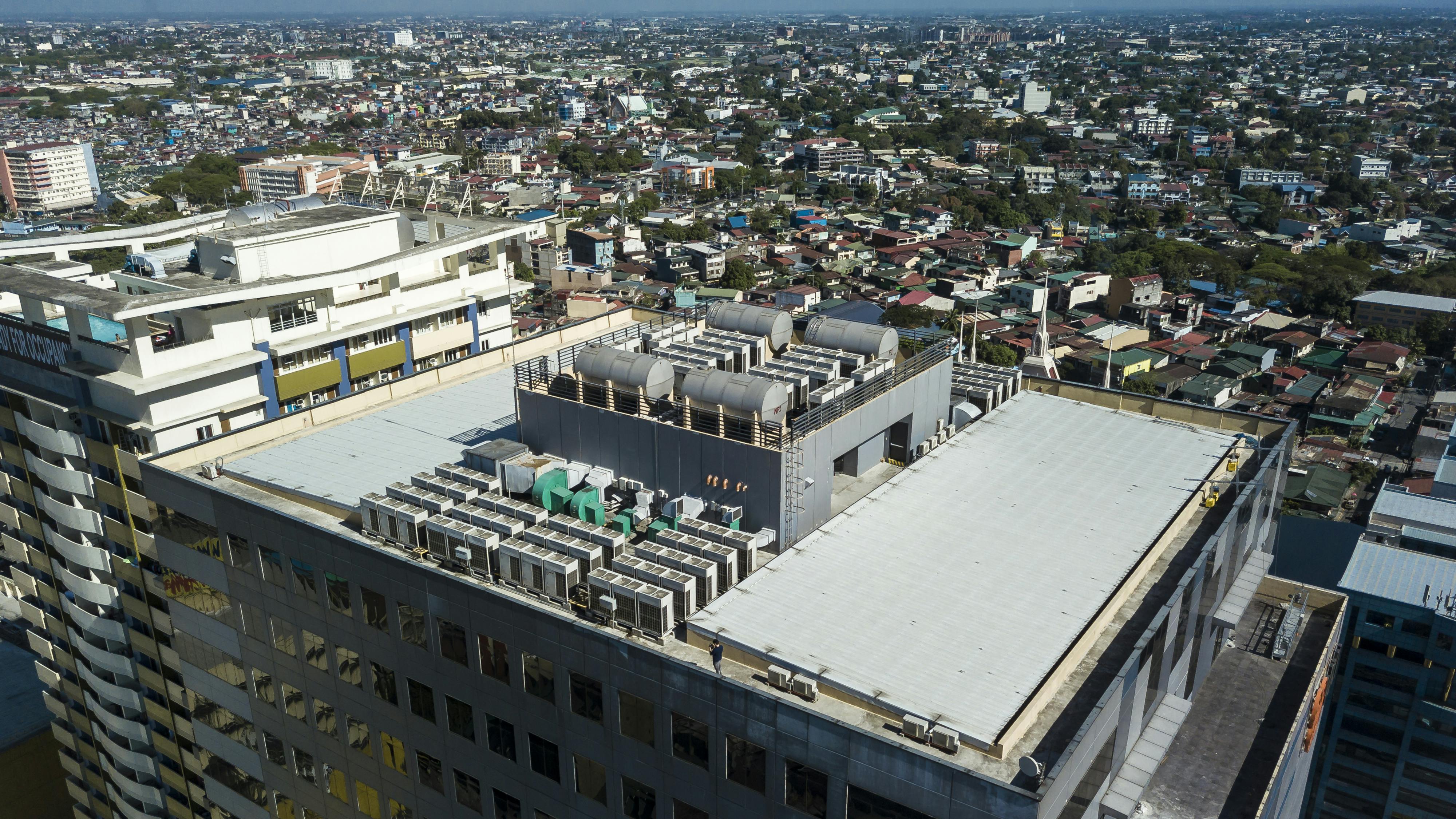 Aerial view of HVAC equipment on rooftop of commercial building.