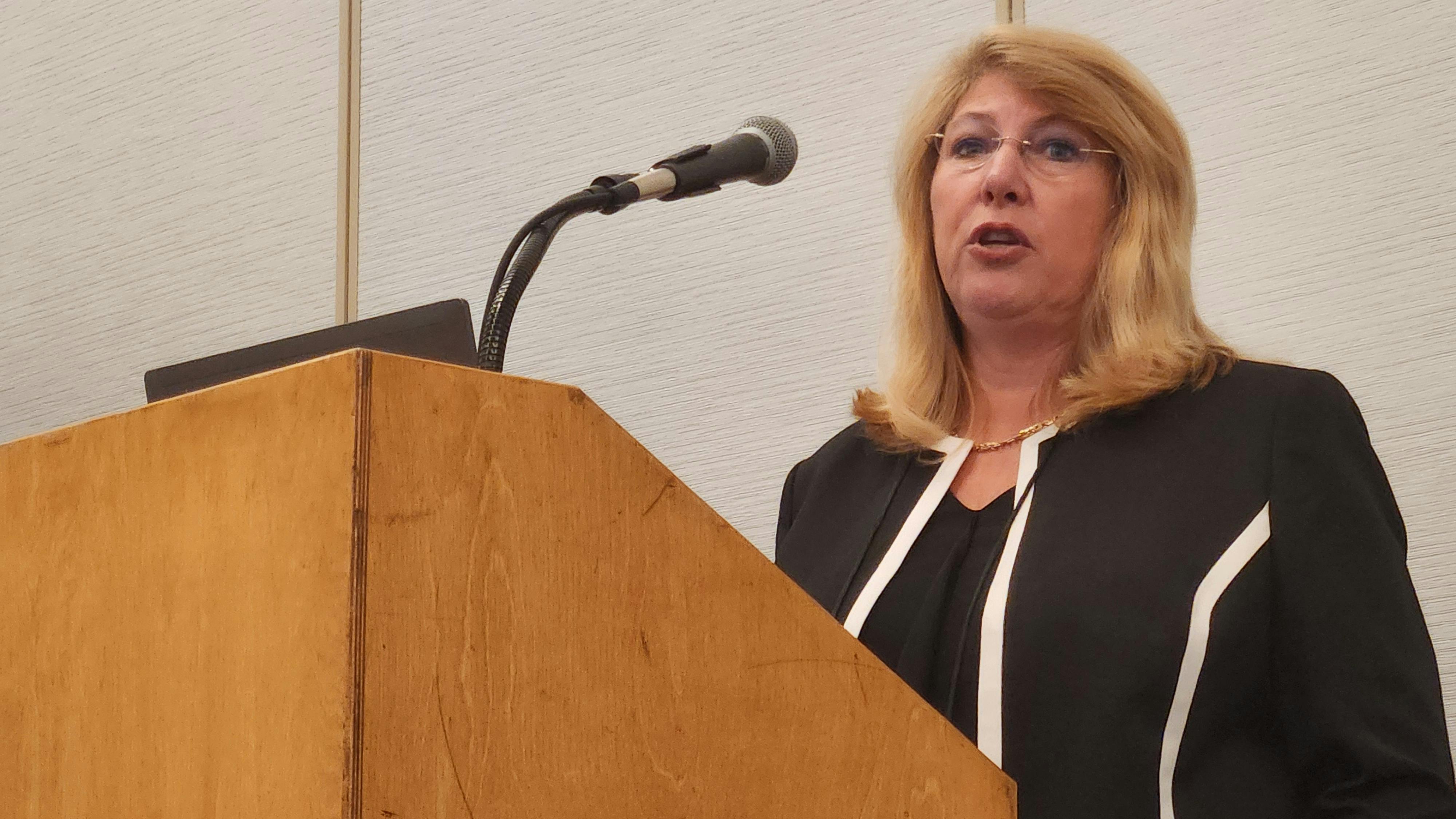 Colette Temmink, EVP, strategy and delivery, for Voxel, addresses attendees at the 2025 IFMA World Workplace conference and expo. Joining her were Marshall MacFarlane, facilities senior project manager for Bell Bank, and Daniel Stonecipher, chief product and technology officer for GeoComm.