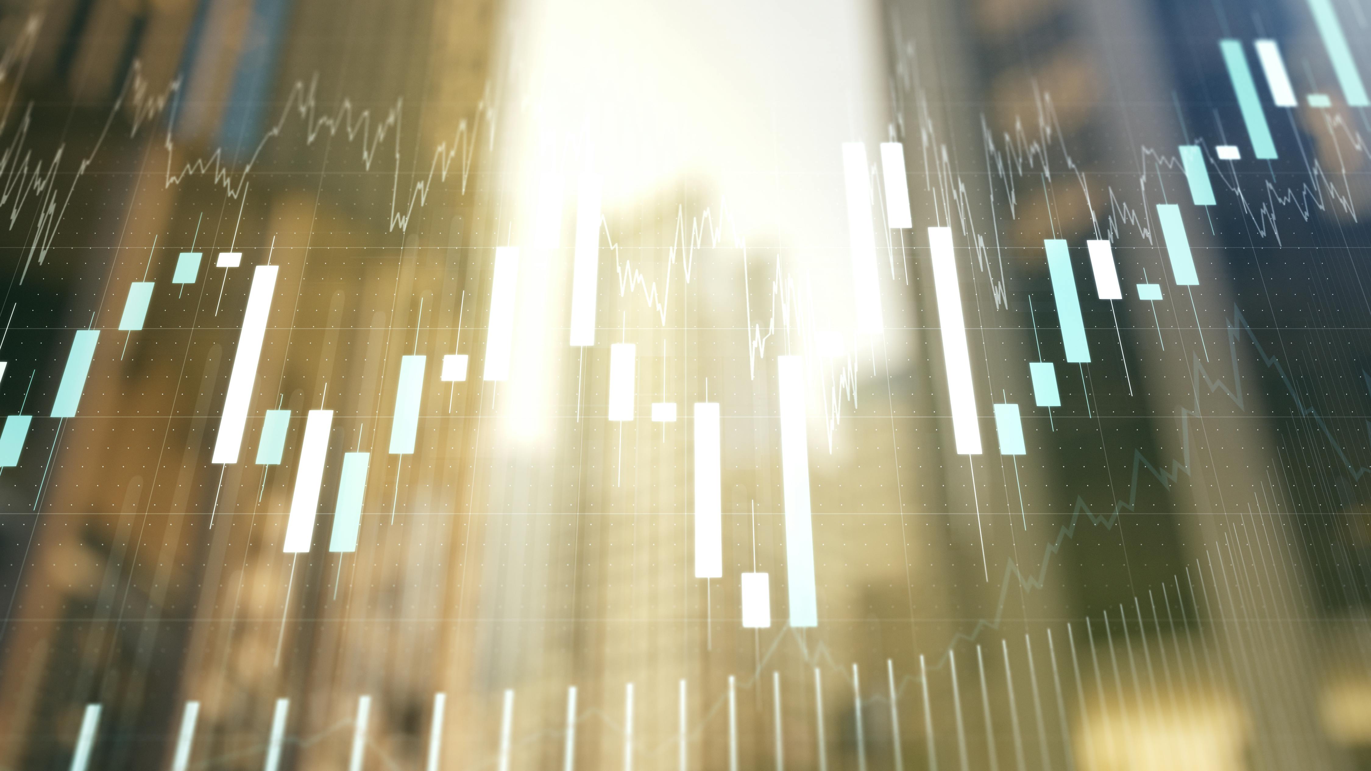 Abstract financial chart showing positive growth overlaid on blurred image of commercial buildings.