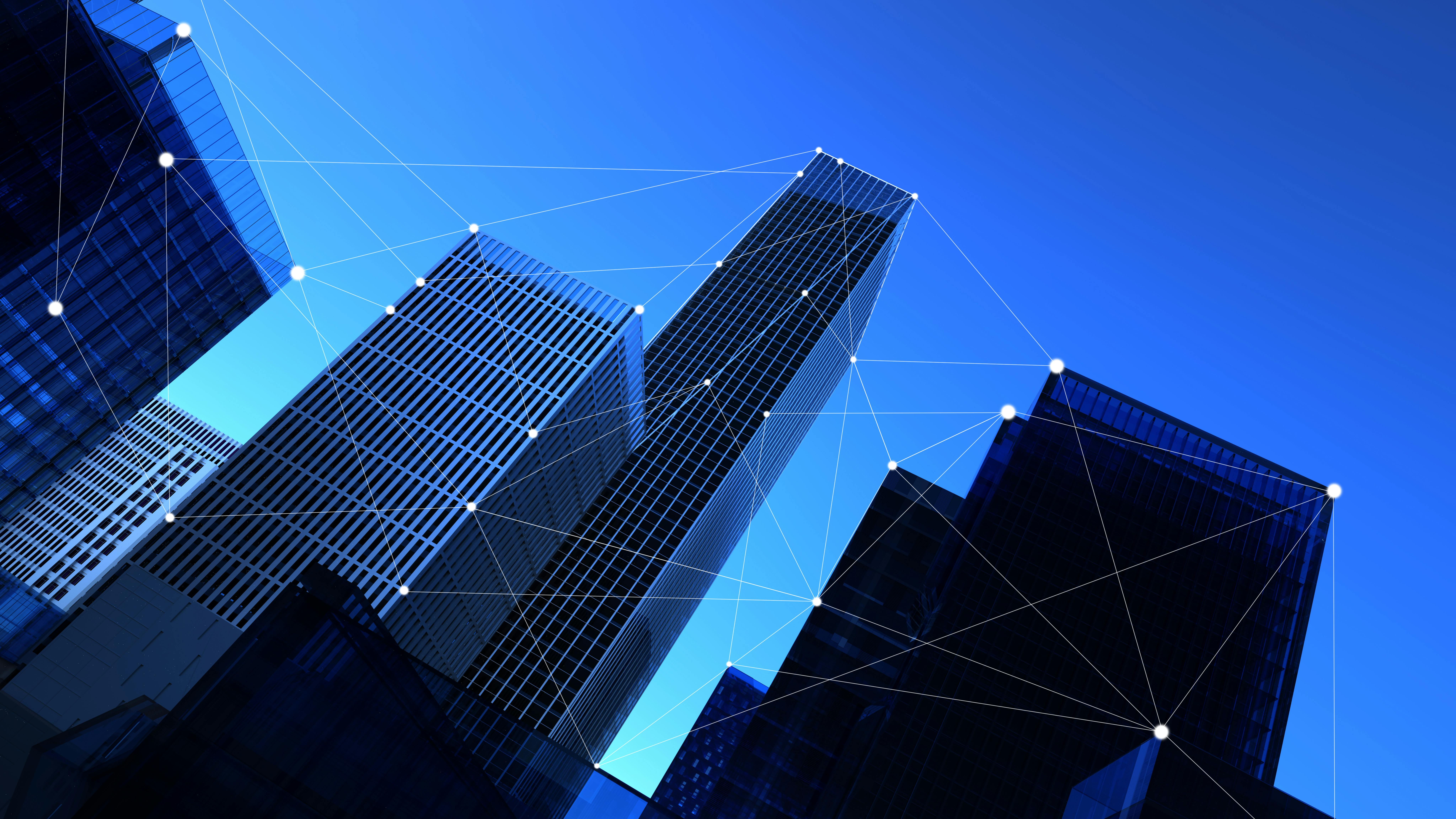 Silhouette of skyscrapers against blue sky with connected data point graphics.