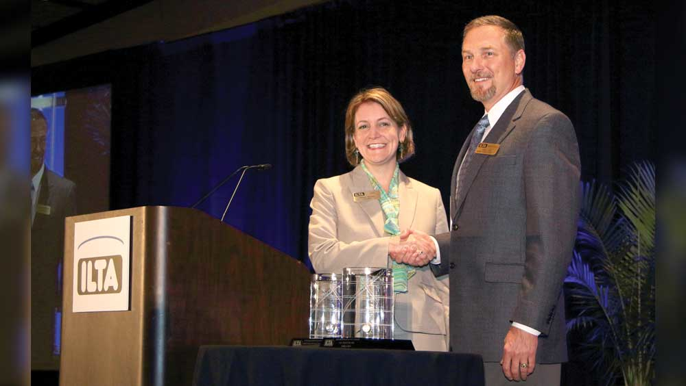Melinda Whitney ILTA president congratulates Tim Aydt Marathon Petroleum Co on receiving the Platinum Safety Award for large company