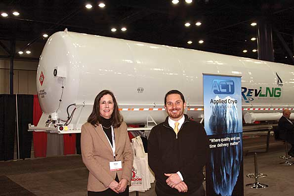 Heidi Bond TransGas LNG and Tim Lowrey Applied Cryo Technologies ACT stand in front of ACTs newly introduced LNG cryogenic trailer that was on display at World LNG Fuels 2013 in Houston TX