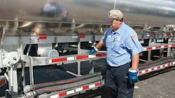 man inspecting tanker man inspecting tanker