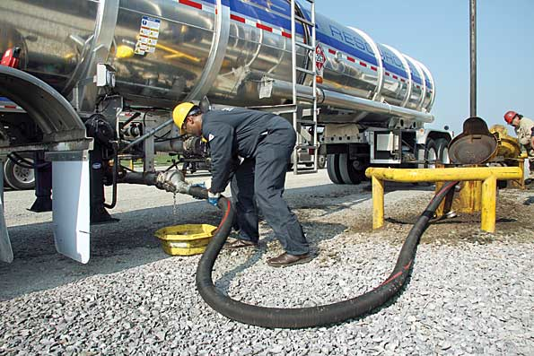 Travis Ramsey a member of the Special Ops team at Sun Coast Resources Inc offloads crude oil at a gathering station near Kilgore TX Houston TXbased Sun Coast has expanded its range of oilfield services to include crude hauling and now has 149 crude transports in service in Texas and Oklahoma