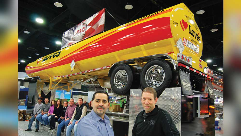 Pictured with the brightly painted show trailer at right foreground are Ed Mansell vicepresident of MAC Liquid Tank Trailers and Jim Maiorana president Seated at left are some of the workers at the Kent and Billings plants who attended the MidAmerica Trucking Show salesmaclttcom