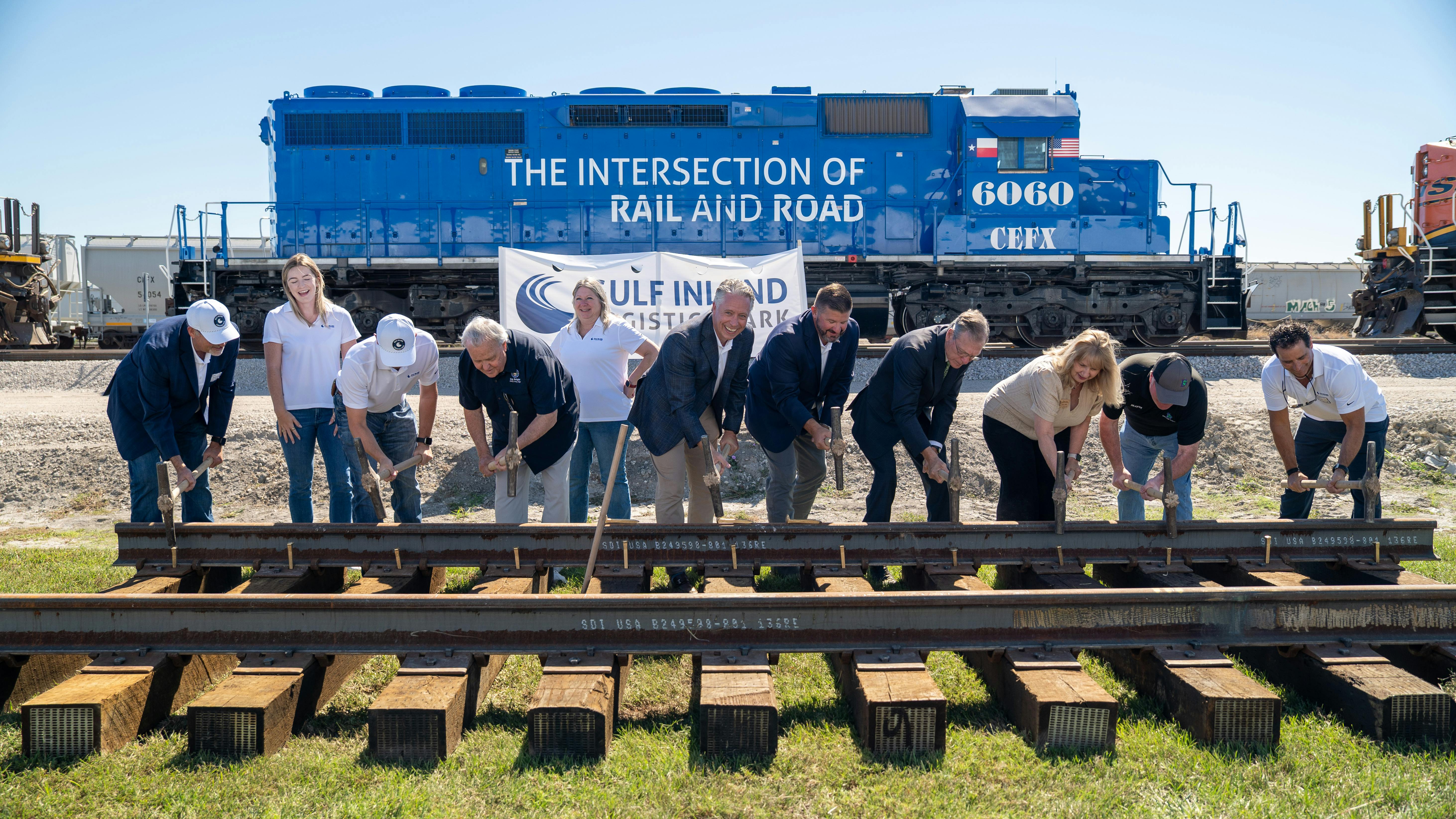 The Gulf Inland Logistics Park team and elected officials take part in a rail spike ceremony.