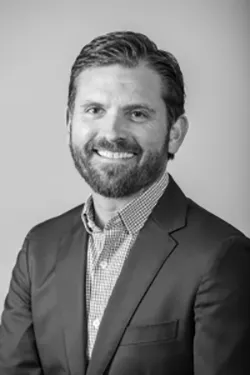 1661879946964 Travisyoungheadshotbw2687x1030200x300 1661879946964 Travisyoungheadshotbw2687x1030200x300