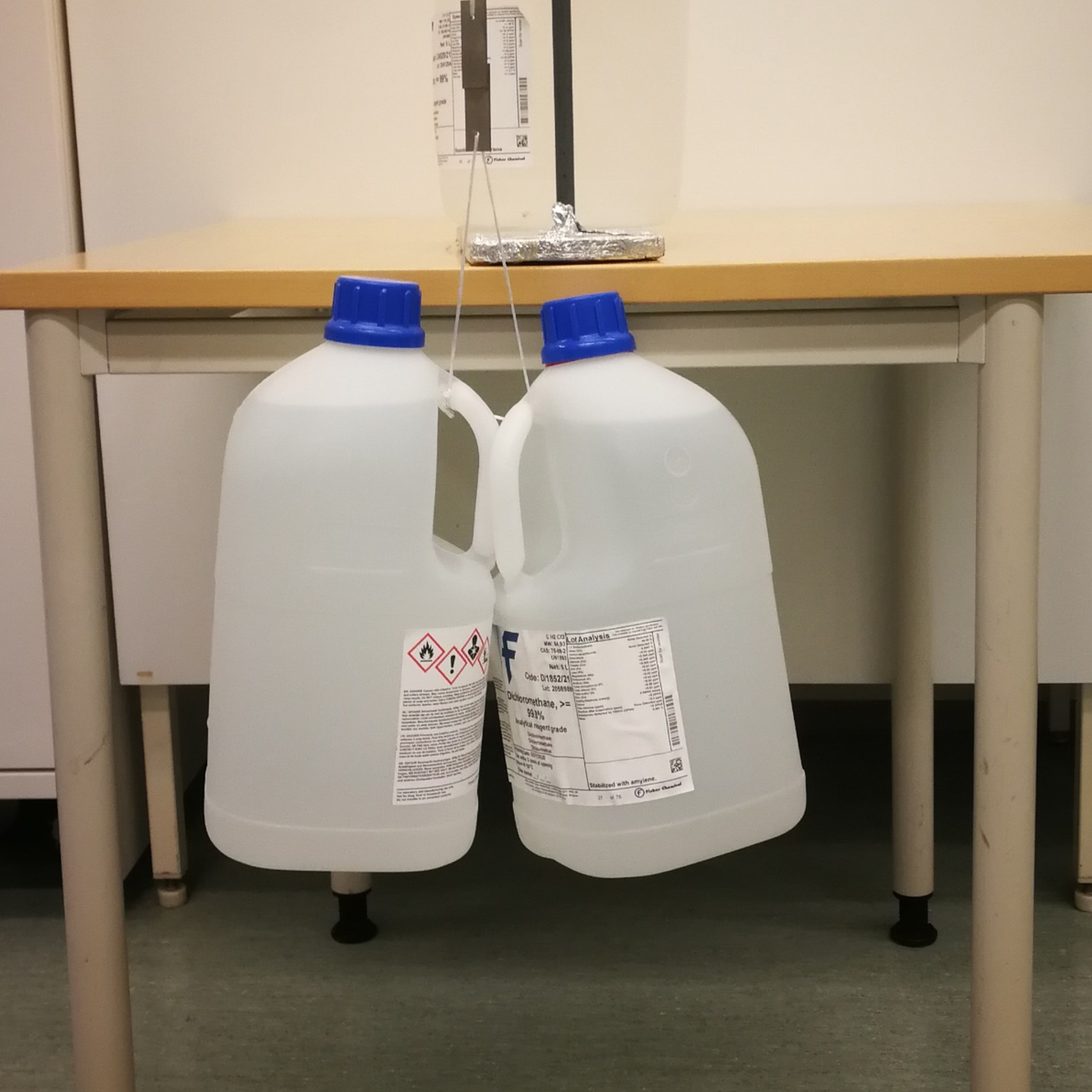 Impressive Adhesion Figure 2. Material held two pieces of steel together strongly enough to suspend two jugs weighing a total of 16 kg for over a month.