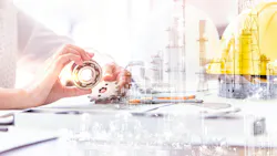 person holding gears with hard hat and industrial plant transposed into image person holding gears with hard hat and industrial plant transposed into image