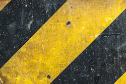 Metal texture with caution sign, scratched surface Metal texture with caution sign, scratched surface