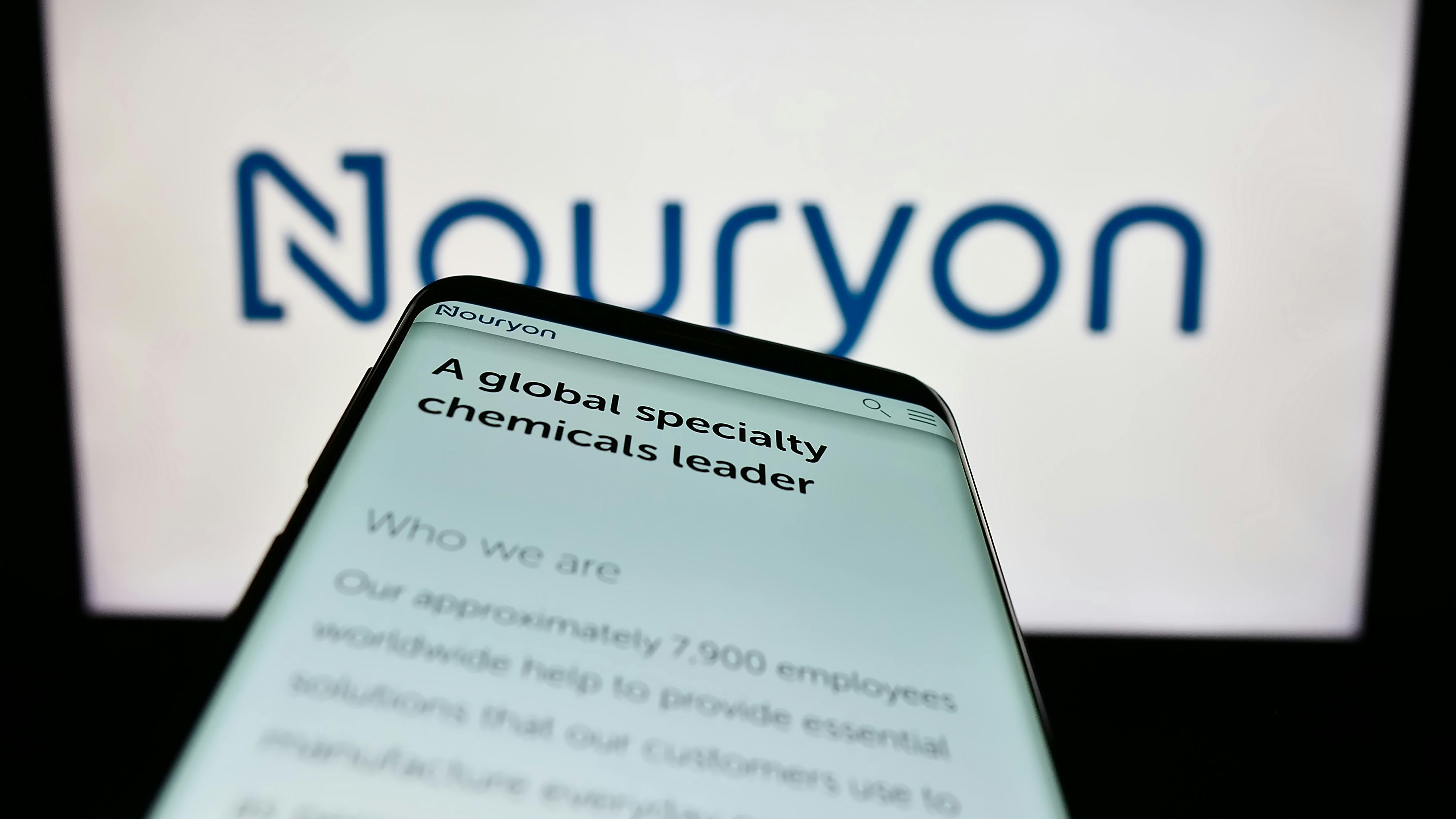 Mobile phone with website of Nouryon Chemicals on screen in front of Nouryon business logo