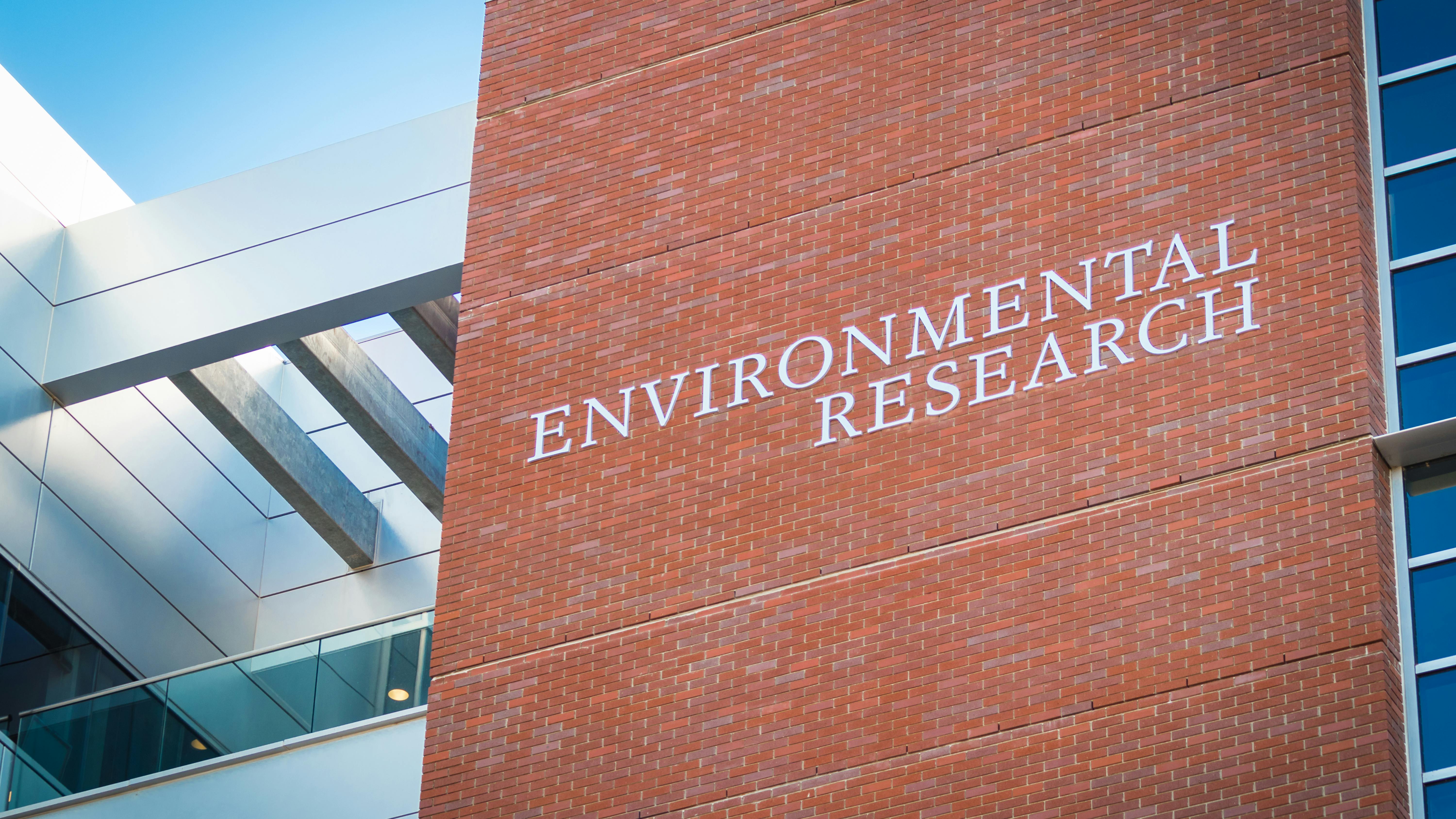 Tall brick building featuring 'ENVIRONMENTAL RESEARCH' sign.