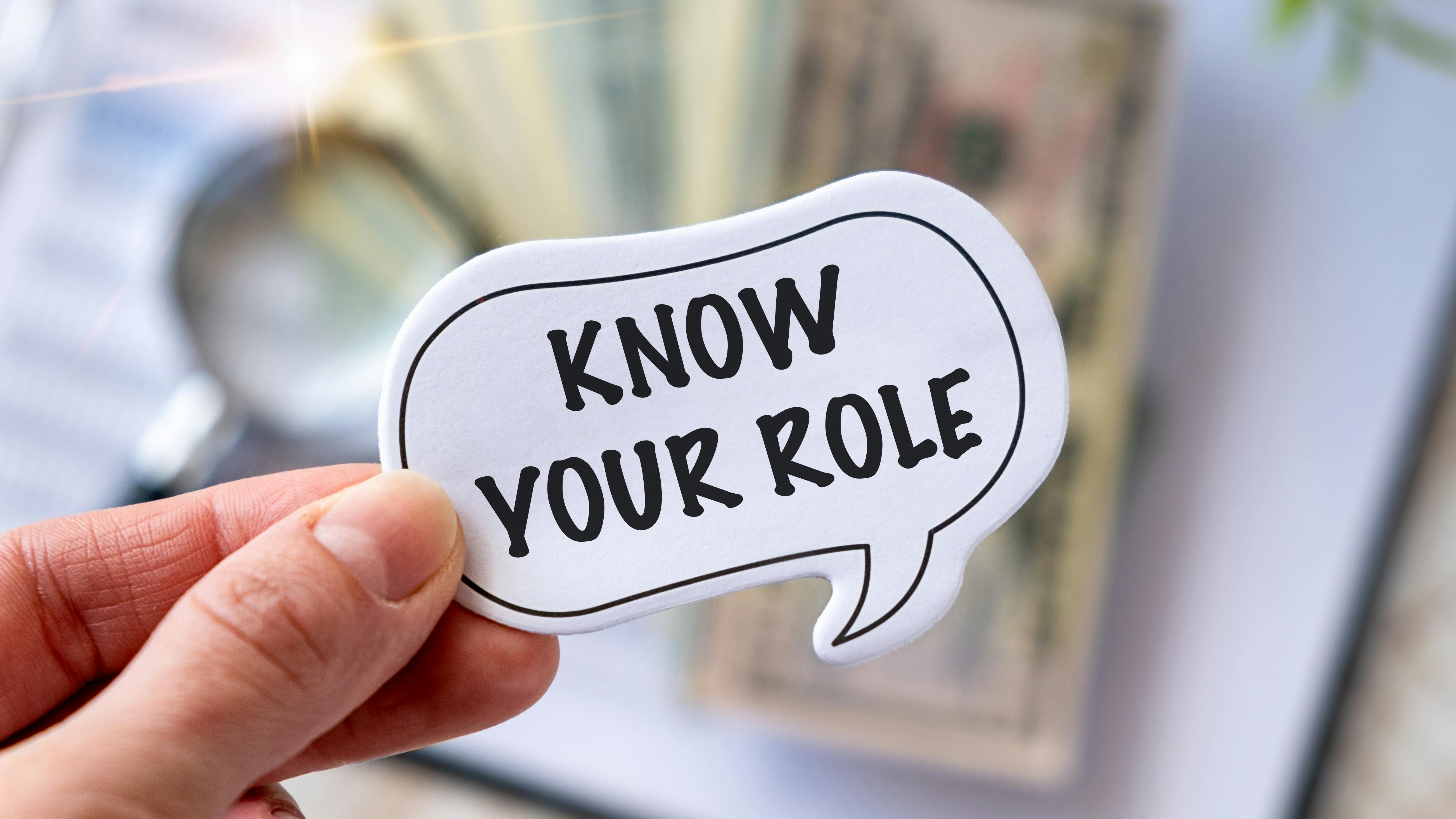 Know Your Role written on a memo stick in hand