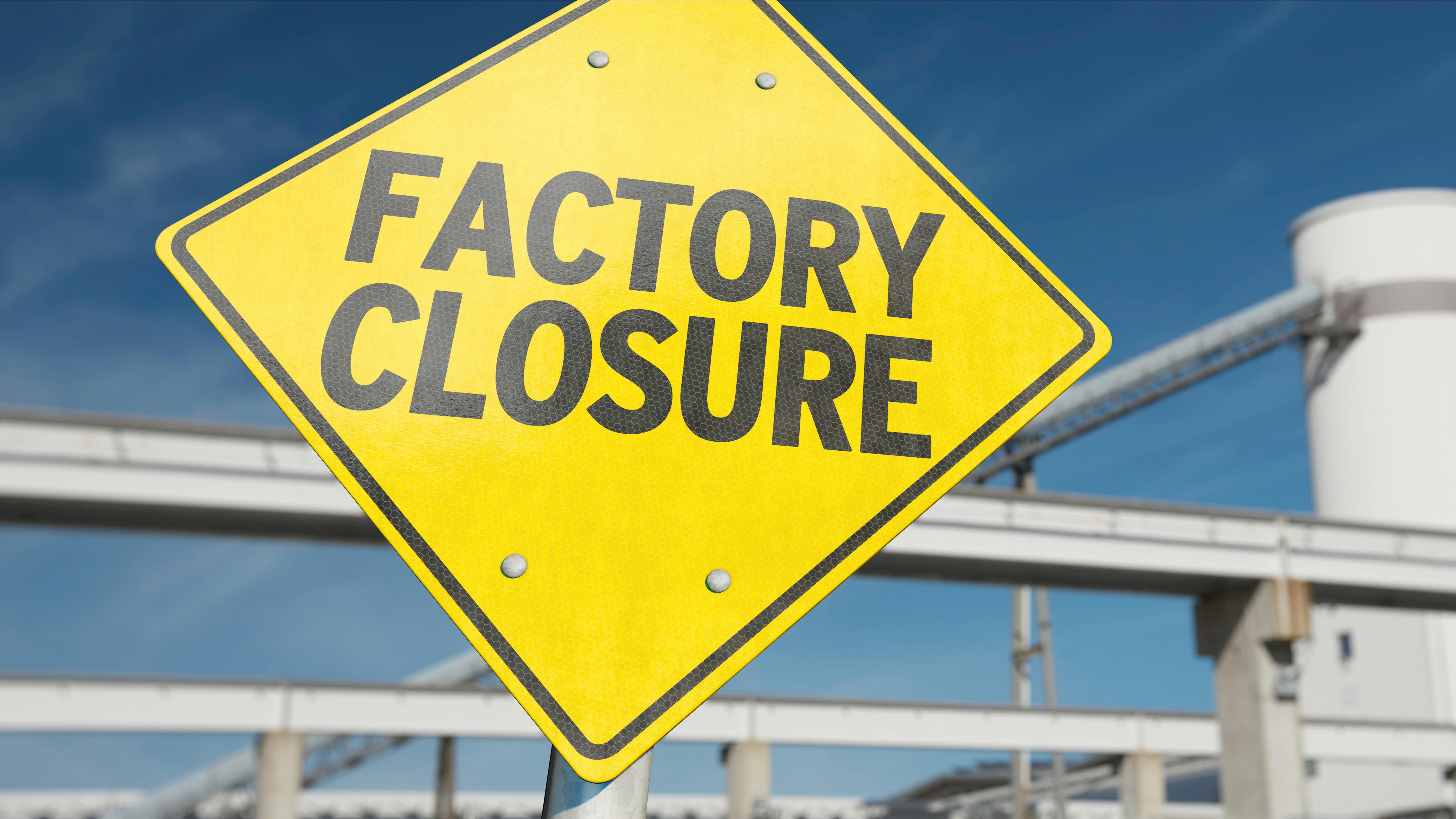 A sign with the word 'FACTORY CLOSURE'