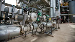 Oil refinery plant. Close up of equipment. Pipes in background. Oil refinery plant. Close up of equipment. Pipes in background.
