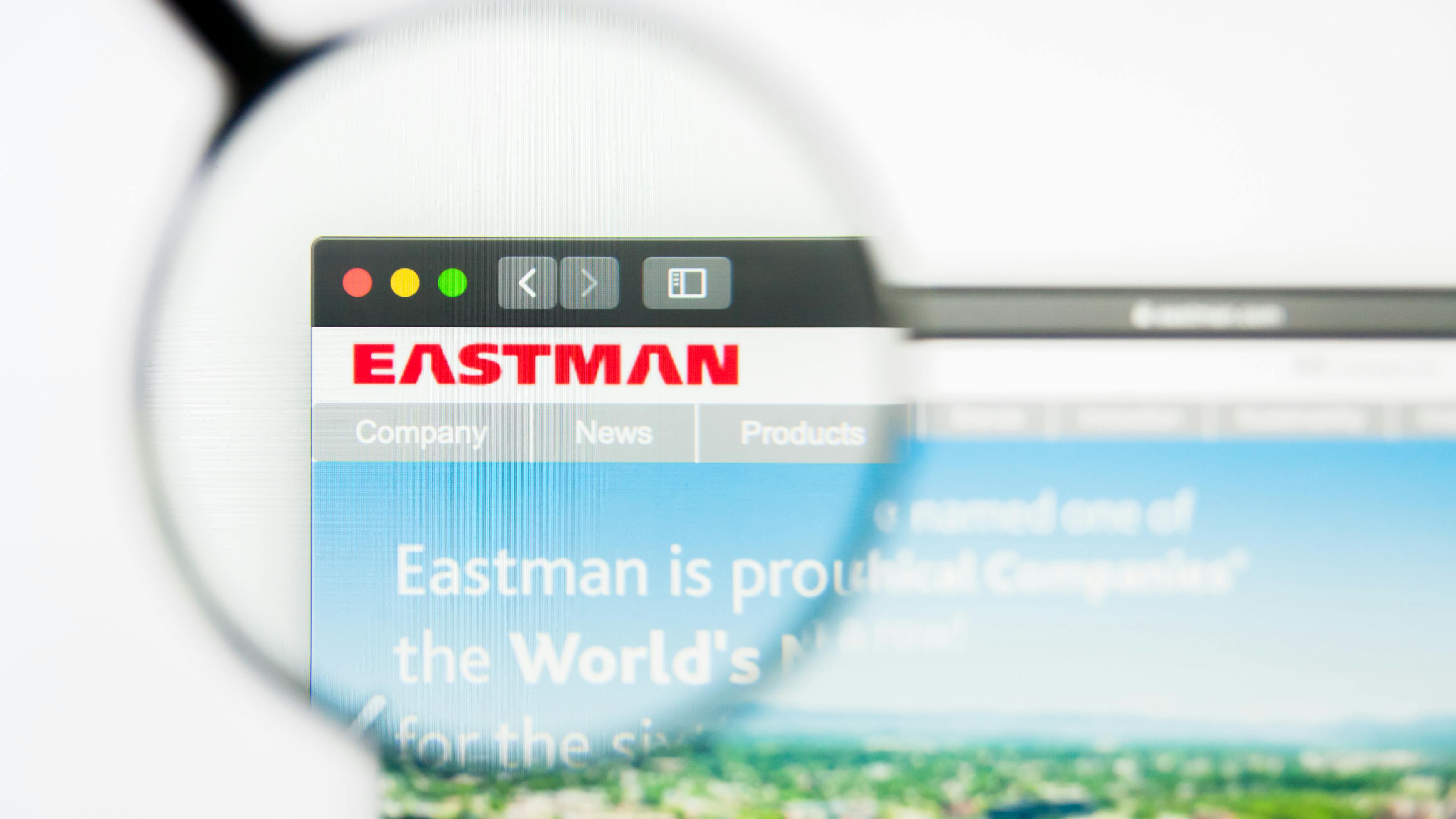 Magnifying glass hovers over Eastman logo on computer screen