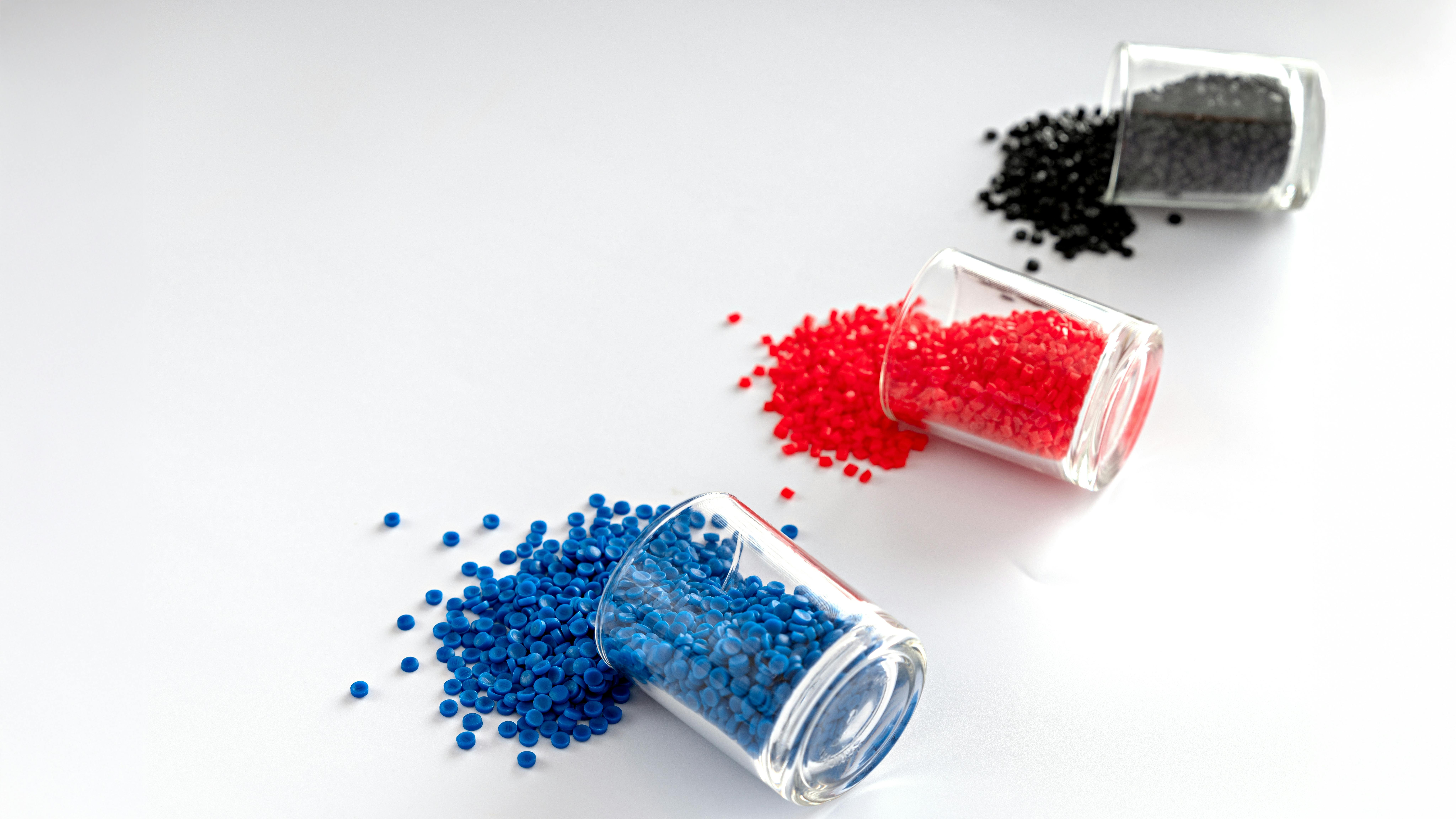 3 vials of plastic polymer granules, made from polyethylene
