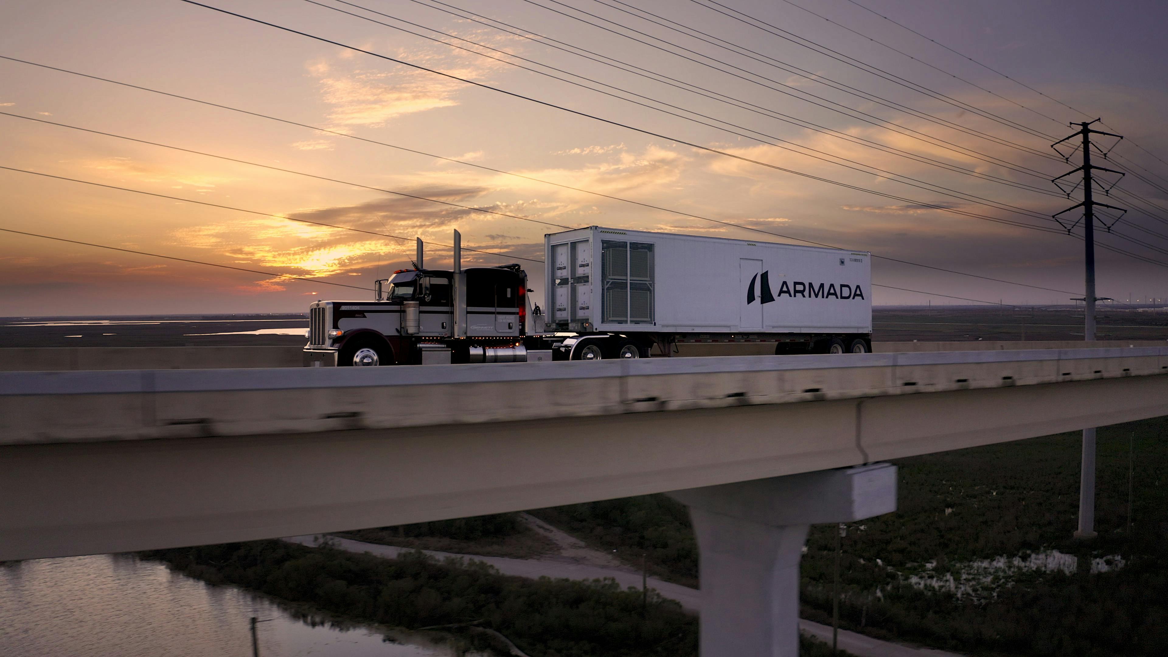 Semi truck pulling Armada modular data center across bridge