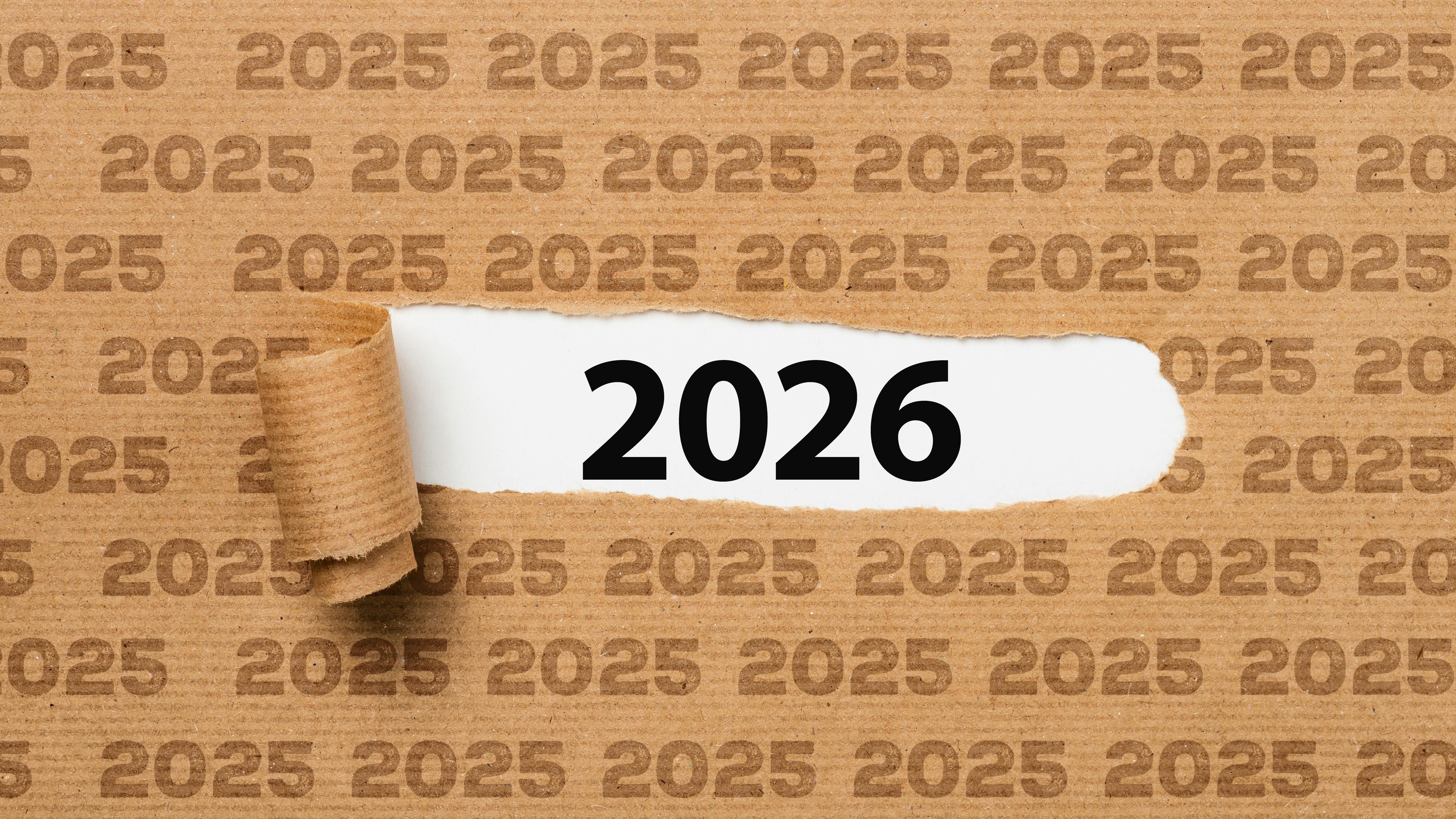 Paper with text 2025 ripped to show 2026 underneath it