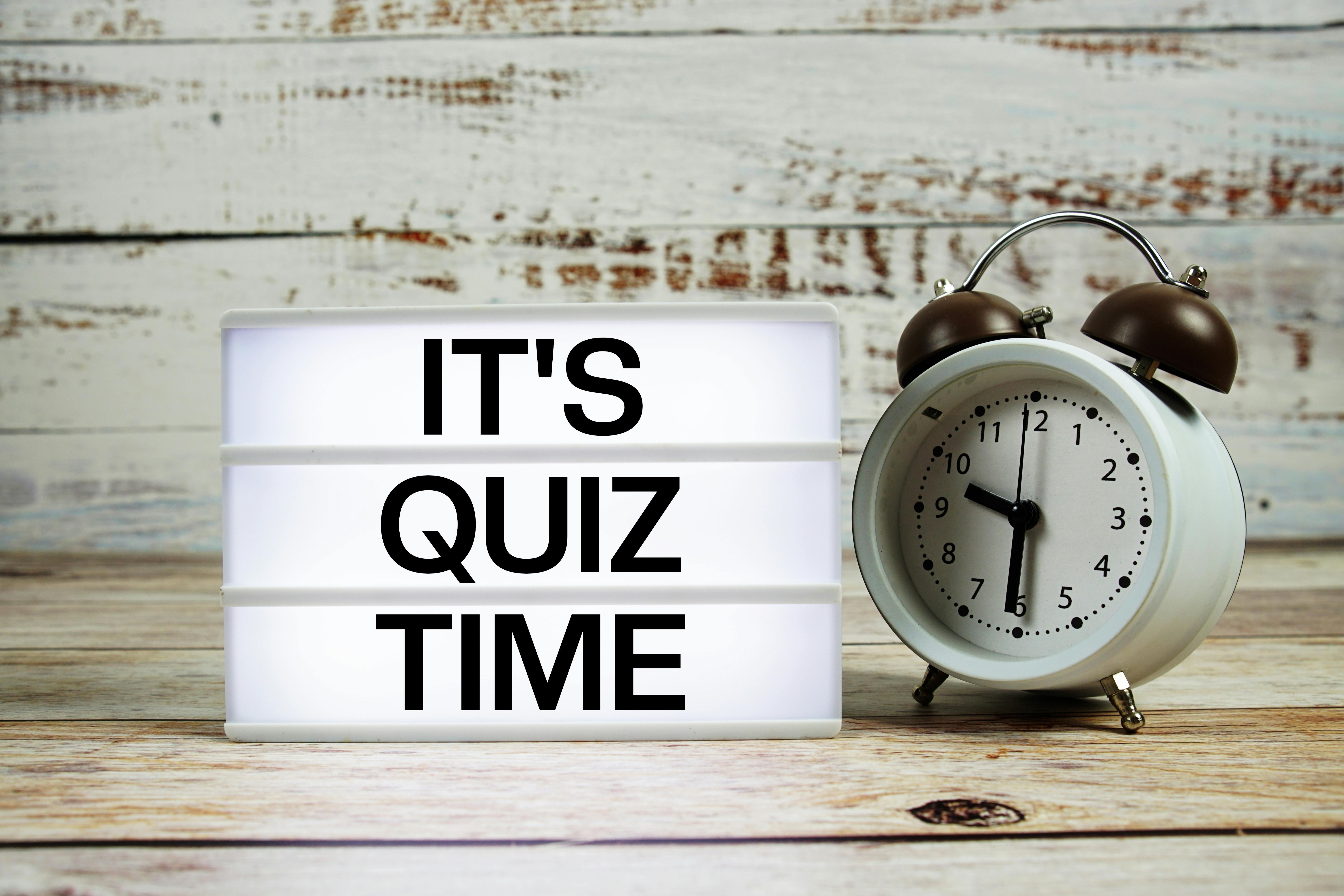 It's Quiz Time marquee with an alarm clock to introduce a trivia quiz for chemical engineers