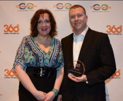 Joshua Shaw, Concert Technologies&rsquo; vice president of sales, accepts Concert&rsquo;s Channel Partners 360 Business Value Award from Channel Partners magazine executive editor Lorna Garey.