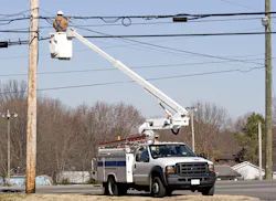 Cable technician working in a bucket truck. Cable technician working in a bucket truck.