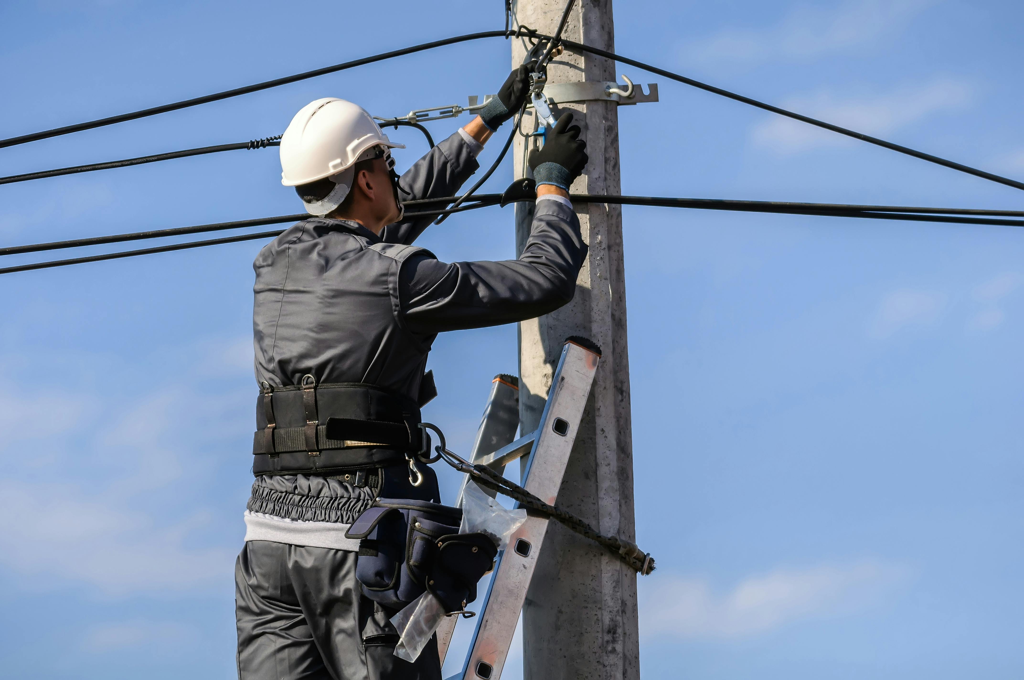Telecommunications technician line worker on pole