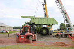 The big moment, as a Link-Belt HTC86100 and Grove RT880E lower Terex Titan’s restored dump bed into place. The Taylor 26-ton forklift assisted one crane in rolling the bed into lifting position after its halves were welded together. The big moment, as a Link-Belt HTC86100 and Grove RT880E lower Terex Titan’s restored dump bed into place. The Taylor 26-ton forklift assisted one crane in rolling the bed into lifting position after its halves were welded together.