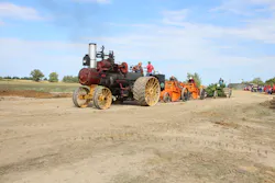 A 1918 Russell & Co. 30/90 traction engine pulls two 1920s Baker Maney D wheeled scrapers and a 1929 Galion Leaning Wheel E-Z Lift No. 10 pull grader. A 1918 Russell & Co. 30/90 traction engine pulls two 1920s Baker Maney D wheeled scrapers and a 1929 Galion Leaning Wheel E-Z Lift No. 10 pull grader.